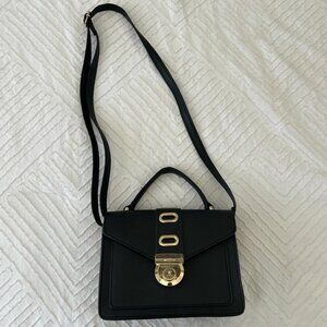 black shoulder bag with a gold buckle